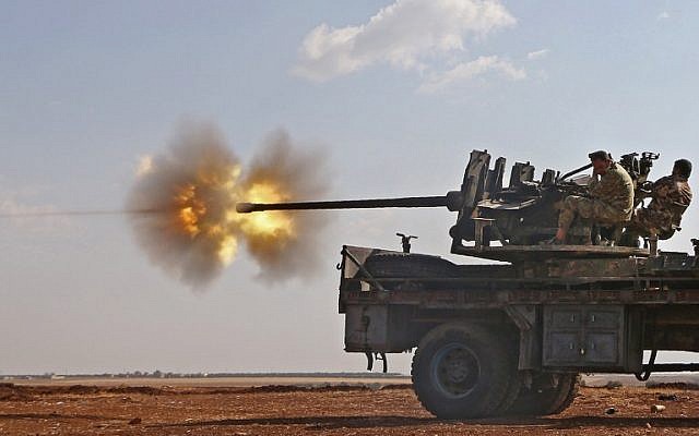 Fighters from the Free Syrian Army fire an anti-aircraft machine gun mounted on a vehicle deploy during fighting against the Islamic State (IS) group jihadists in the northern Syrian village of Yahmoul in the Marj Dabiq area north of the embattled city of Aleppo on October 10, 2016.(AFP PHOTO / Nazeer al-Khatib)