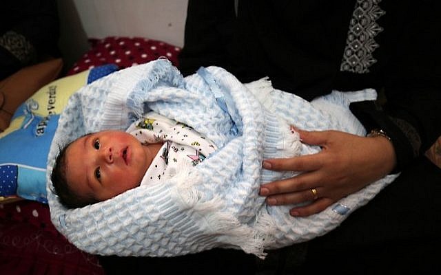 Tahany Shaath holds her three-day old new-born son Waleed at their house in the southern Gaza Strip town of Rafah on October 12, 2016. (AFP/Said Khatib) Tahany Shaath holds her three-day old new-born son Waleed at their house in the southern Gaza Strip town of Rafah on October 12, 2016. (AFP/Said Khatib)