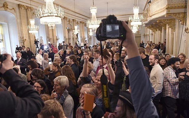 The audience reacts as Permanent Secretary of the Swedish Academy Sara Danius announces that Bob Dylan is awarded the 2016 Nobel Prize in Literature during a presser at the Old Stockholm Stock Exchange Building in Stockholm, October 13, 2016. (AFP/TT News Agency/Jonas Ekstromer) The audience reacts as Permanent Secretary of the Swedish Academy Sara Danius announces that Bob Dylan is awarded the 2016 Nobel Prize in Literature during a presser at the Old Stockholm Stock Exchange Building in Stockholm, October 13, 2016. (AFP/TT News Agency/Jonas Ekstromer)
