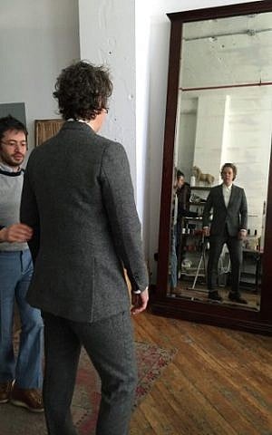 Daniel Friedman, founder of the tailoring shop Bindle & Keep, during a fitting with Ashley Merriman, a client of the shop who came to try on a new custom-made androgynous suit, October 14, 2016. (AFP Photo/Catherine Triomphe)