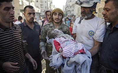 Members of the Syrian Civil Defense, known as the White Helmets, carry the body of a baby girl from the rubble of a destroyed building following reported airstrikes in the rebel-held Qatarji neighborhood of Aleppo on October 17, 2016. (AFP PHOTO/KARAM AL-MASRI)