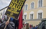 Anti-Nazi protesters gather outside the house where Adolf Hitler was born in Braunau Am Inn, Austria, on April 18, 2015. (AFP/Joe Klamar)