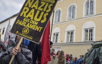 Anti-Nazi protesters gather outside the house where Adolf Hitler was born in Braunau Am Inn, Austria, on April 18, 2015. (AFP/Joe Klamar)