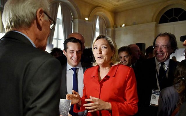 French far-right leader Marine Le Pen, center, speaks to a participant at the Salon Planete PME, a forum for French small and medium businesses, on October 18, 2016, in Paris. (Alain Jocard/AFP)