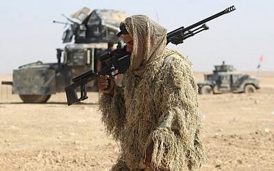 An Iraqi forces member dressed in a camouflage outfit walks in the Bajwaniyah village, about 30 kms south of Mosul, on October 18, 2016 as the forces advance to liberate Mosul from the Islamic State (IS) group jihadists.(AFP PHOTO / AHMAD AL-RUBAYE) An Iraqi forces member dressed in a camouflage outfit walks in the Bajwaniyah village, about 30 kms south of Mosul, on October 18, 2016 as the forces advance to liberate Mosul from the Islamic State (IS) group jihadists.(AFP PHOTO / AHMAD AL-RUBAYE)