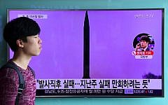 File: A man walks past a television screen showing file footage of a North Korean missile launch at a railway station in Seoul, South Korea, on October 20, 2016. (AFP Photo/Jung Yeon-Je)