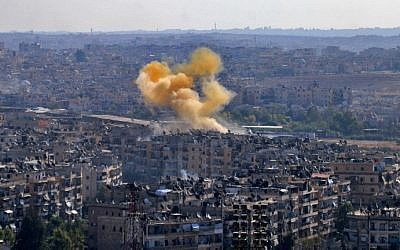 Smoke rises from reported opposition fire from buildings in an eastern government-held neighborhood of the northern Syrian city of Aleppo on October 20, 2016. (AFP/George Ourfalian)