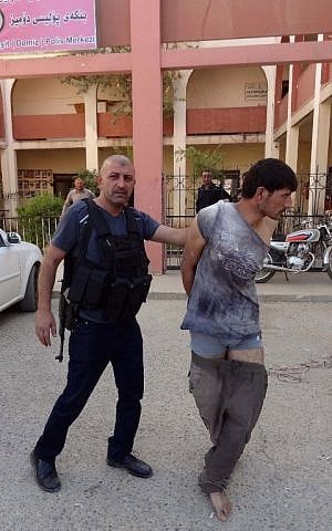 A suspected member of the Islamic State (IS) group is detained by Iraqi Kurdish forces in the southern Domiz neighbourhood of Kirkuk, October 21, 2016. (AFP/Marwan IBRAHIM) A suspected member of the Islamic State (IS) group is detained by Iraqi Kurdish forces in the southern Domiz neighbourhood of Kirkuk, October 21, 2016. (AFP/Marwan IBRAHIM)