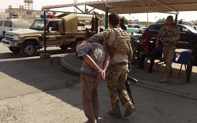 Iraqi Kurdish security forces escort a suspected member of the Islamic State group who was arrested the previous day during clashes in the southern suburbs of Kirkuk, October 22, 2016. (AFP/Marwan IBRAHIM) Iraqi Kurdish security forces escort a suspected member of the Islamic State group who was arrested the previous day during clashes in the southern suburbs of Kirkuk, October 22, 2016. (AFP/Marwan IBRAHIM)