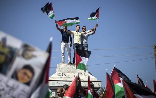 Palestinians in Gaza wave Palestinian flags during a demonstration in support of  national unity on October 22, 2016 in Gaza City. (AFP PHOTO / MAHMUD HAMS)