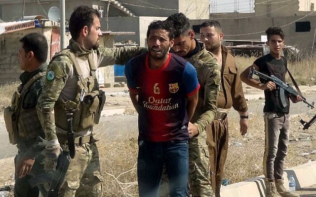 Iraqi Kurdish security forces detain a suspected member of the Islamic State (IS) group as they patrol the eastern suburbs of Kirkuk on October 22, 2016. (AFP/Marwan IBRAHIM) Iraqi Kurdish security forces detain a suspected member of the Islamic State (IS) group as they patrol the eastern suburbs of Kirkuk on October 22, 2016. (AFP/Marwan IBRAHIM)