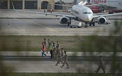 Members of Malta's Armed Forces check the runway after a small passenger aircraft crashed on takeoff at Malta's international airport on October 24, 2016, killing all five people onboard, officials said. (AFP/Matthew Mirabelli)
