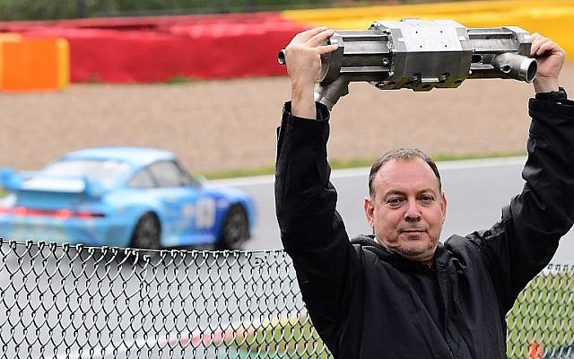 Gal Fridman, co-founder of Aquarius Engines, poses with the company's single-piston car engine at Campus Automobile Spa-Francorchamps in Belgium on October 19, 2016. (AFP PHOTO/EMMANUEL DUNAND)