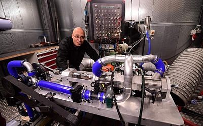 Shaul Yakobi, inventor and co-founder at Aquarius Engines, poses for a photo with the single-piston car engine he invented, at Campus Automobile Spa-Francorchamps in Belgium on October 19, 2016. (AFP/Emmanuel Dunand)