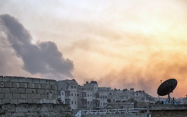 Smoke billows from the frontline district of Dahiyet al-Assad following an attack by rebels on Syrian regime forces in the northern city of Aleppo on October 29, 2016. (AFP/ KARAM AL-MASRI)