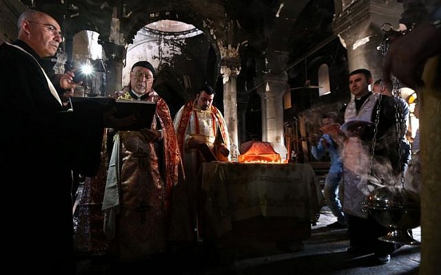 Archbishop Yohanna Petros Mouche (2-L) of Mosul leads a mass at the Church of the Immaculate Conception on October 30, 2016 in the town of Qaraqosh (also known as Hamdaniya), 30 kms east of Mosul, after Iraqi forces recaptured it from Islamic State (IS) group jihadists. (AFP/ SAFIN HAMED) Archbishop Yohanna Petros Mouche (2-L) of Mosul leads a mass at the Church of the Immaculate Conception on October 30, 2016 in the town of Qaraqosh (also known as Hamdaniya), 30 kms east of Mosul, after Iraqi forces recaptured it from Islamic State (IS) group jihadists. (AFP/ SAFIN HAMED)