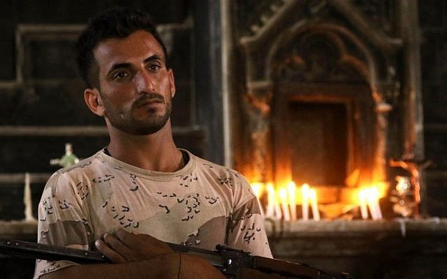 An Iraqi Christian forces member stands in the Church of the Immaculate Conception on October 30, 2016 in the town of Qaraqosh (also known as Hamdaniya), 30 kms east of Mosul, after Iraqi forces recaptured it from Islamic State (IS) group jihadists. (AFP/ SAFIN HAMED) An Iraqi Christian forces member stands in the Church of the Immaculate Conception on October 30, 2016 in the town of Qaraqosh (also known as Hamdaniya), 30 kms east of Mosul, after Iraqi forces recaptured it from Islamic State (IS) group jihadists. (AFP/ SAFIN HAMED)