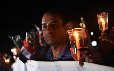 People light candles during a ceremony to mark the first anniversary of the Russian MetroJet plane crash on October 30, 2016 in the Egyptian Red Sea resort of Sharm el-Sheikh. (AFP/ MOHAMED EL-SHAHED)