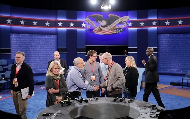 ABC News' Martha Raddatz, second left, looks at the desk from where she will co-moderate a debate between Republican presidential nominee Donald Trump and Democratic presidential nominee Hillary Clinton at Washington University, in St Louis, Missouri, seen here on October 8, 2016. (Chip Somodevilla/Getty Images/AFP)