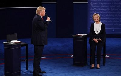Republican presidential nominee Donald Trump, left, speaks as Democratic presidential nominee  Hillary Clinton looks on during the town hall debate at Washington University on October 9, 2016 in St Louis, Missouri. (Win McNamee/Getty Images/AFP)