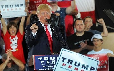 Republican presidential nominee Donald Trump greets supporters during a rally at Southeastern Livestock Pavillion on October 12, 2016 in Ocala, Florida. (Gerardo Mora/Getty Images/AFP)