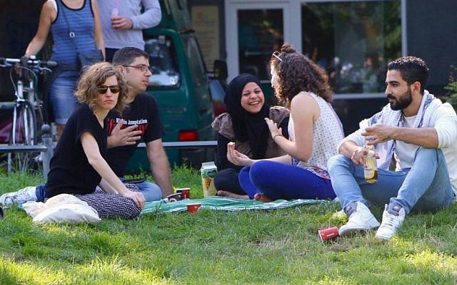 IsraAID volunteers and Middle Eastern refugees at a picnic in Berlin, summer 2016 (Hillel Zand)