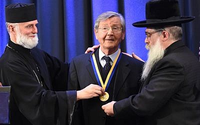 Bishop Borys Gudziak of the Ukrainian Catholic Church (L) and Ukraine Chief Rabbi Yaakov Dov Bleich (R) award Ivan Dzyuba the Metropolitan Andrey Sheptytsky Medal on behalf of the Ukrainian Jewish Encounter and the Jewish Confederation of Ukraine in Kiev, Ukraine on September 26, 2016. (Shahar Azran/WJC)