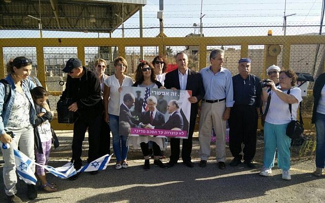 MK Hilik Bar (4th right) attends an anti-war protest at the Quneitra Crossing on the Syrian border, October 18, 2016. Bar is holding a poster of Sadat, Carter and Begin clasping hands at the White House signing of a 1979 Israel-Egypt peace treaty.