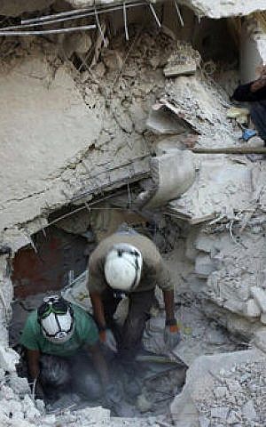 Civil Defense workers from the White Helmets digging in the rubles to remove bodies and look for survivors, after airstrikes in Aleppo, Syria. October 4, 2016 (Syrian Civil Defense White Helmets via Associated Press) Civil Defense workers from the White Helmets digging in the rubles to remove bodies and look for survivors, after airstrikes in Aleppo, Syria. October 4, 2016 (Syrian Civil Defense White Helmets via Associated Press)