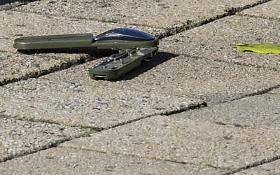 Part of a knife lies on the ground behind a cordon as police investigate the scene where a man stabbed two officers, in the Schaerbeek neighborhood in Brussels on Wednesday, Oct. 5, 2016. (AP Photo/Olivier Matthys)