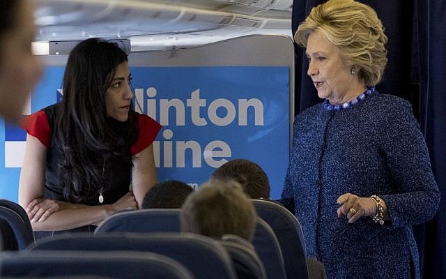 Democratic nominee Hillary Clinton speaks with senior aide Huma Abedin aboard her campaign plane before traveling to Iowa for rallies. (Andrew Harnik/AP)