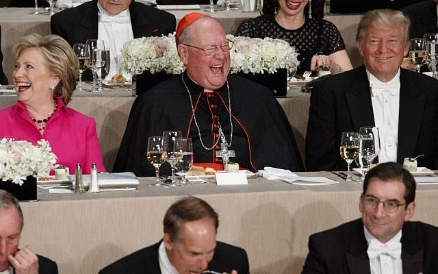Republican presidential candidate Donald Trump, right, laughs at a joke with Cardinal Timothy Dolan, center, and Democratic presidential candidate Hillary Clinton during the Alfred E. Smith Memorial Foundation dinner, Thursday, Oct. 20, 2016, in New York. (AP/ Evan Vucci)