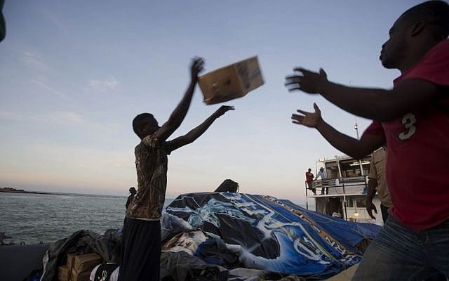 People unload food and water boated in from the "Mission of Hope" charity after Hurricane Matthew swept through Jeremie, Haiti, Saturday, Oct. 8, 2016. (AP Photo/Dieu Nalio Chery) 