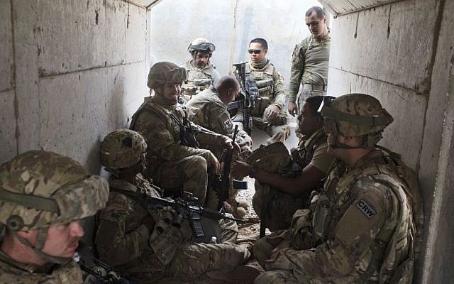 US military personnel sit in a bunker as an incoming mortar alarm is called at a coalition air base in Qayara, some 50 kilometers south of Mosul, Iraq, Friday, Oct. 28, 2016. (AP Photo/Marko Drobnjakovic) 
