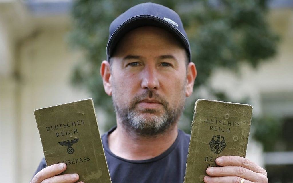 In this Wednesday, Oct. 5, 2016 photo, author Thomas Harding shows passports of his grandparents in London. Harding is doing what other descendants of Holocaust victims would find unimaginable: applying for a German passport. (AP Photo/Frank Augstein) In this Wednesday, Oct. 5, 2016 photo, author Thomas Harding shows passports of his grandparents in London. Harding is doing what other descendants of Holocaust victims would find unimaginable: applying for a German passport. (AP Photo/Frank Augstein)