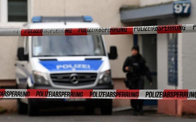 Police officers secure a cordoned off residential property in a housing estate in Chemnitz, eastern Germany, Sunday, Oct. 9, 2016, where police have been investigating a possible bomb plot.  (Hendrik Schmidt/dpa via AP)