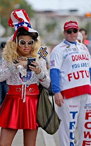 Clinton supporter Lady Guy, left, a Manor Complex employee and Trump supporter Janusz Biskupek are among the crowd outside the hall as Democratic presidential nominee Hillary Clinton holds a rally at The Manor Complex in Wilton Manors, October 20, 2016. (Patrick Farrell/Miami Herald via AP) 