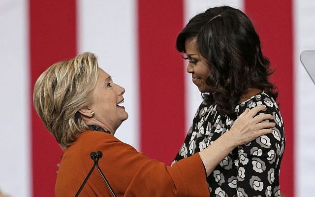 Democratic presidential candidate Hillary Clinton prepares to hug first lady Michelle Obama during a campaign rally in Winston-Salem, N.C., Thursday, Oct. 27, 2016. (AP/Chuck Burton)