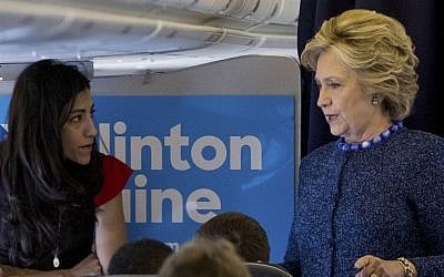 In this Oct. 28, 2016 file photo, Democratic presidential candidate Hillary Clinton speaks with senior aide Huma Abedin aboard her campaign plane at Westchester County Airport in White Plains. (AP/Andrew Harnik)