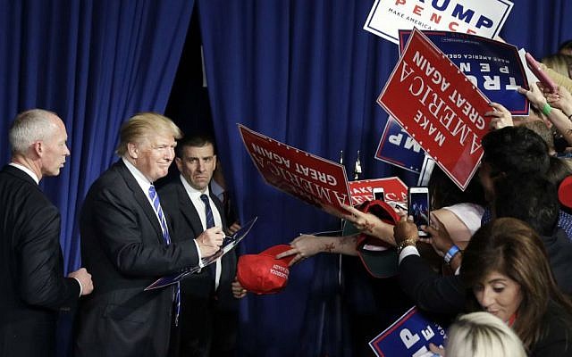 Republican presidential candidate Donald Trump meets with supporters after a rally, Friday, Sept. 30, 2016, in Novi, Michigan. (AP Photo/John Locher)