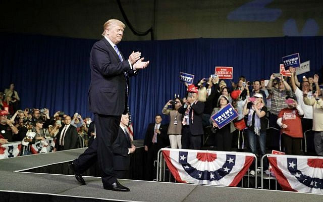 Republican presidential candidate Donald Trump takes the stage at a rally, Friday, Sept. 30, 2016, in Novi, Michigan. (AP Photo/John Locher)