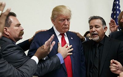 Pastors from the Las Vegas area pray with then Republican presidential candidate Donald Trump during a visit to the International Church of Las Vegas and International Christian Academy, Wednesday, Oct. 5, 2016, in Las Vegas, Nevada. (AP Photo/Evan Vucci)