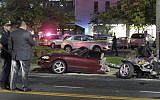 Police survey the wreckage of a Mazda Miata that was split in half after a collision with a Mercedes-Benz in Rockville Centre, on New York's Long Island, Friday Oct. 14, 2016. (Paul Mazza/Newsday via AP)