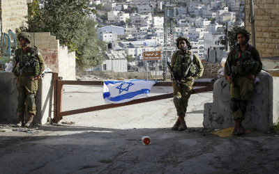 Illustrative. Israeli soldiers guard a checkpoint in the West Bank city of Hebron, on September 21 2016. (Wisam Hashlamoun/Flash90)