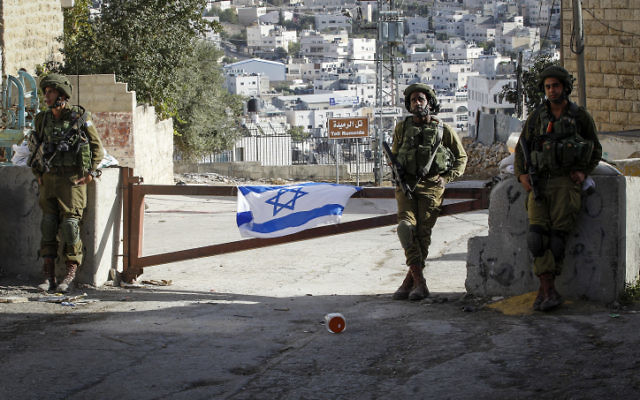Israeli soldiers guard a checkpoint in the West Bank city of Hebron, on September 21, 2016. (Wisam Hashlamoun/Flash90) Israeli soldiers guard a checkpoint in the West Bank city of Hebron, on September 21, 2016. (Wisam Hashlamoun/Flash90)