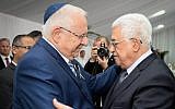 President Reuven Rivlin, right, meets Palestinian Authority President Mahmoud Abbas during the funeral for late former president Shimon Peres at Mount Herzl Cemetery in Jerusalem, on September 30, 2016. (Mark Neyman/GPO)