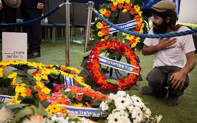 A man mourns at the grave of former President Shimon Peres after his state funeral at Mount Herzl Cemetery in Jerusalem, on September 30, 2016. (Hadas Parush/Flash90) A man mourns at the grave of former President Shimon Peres after his state funeral at Mount Herzl Cemetery in Jerusalem, on September 30, 2016. (Hadas Parush/Flash90)