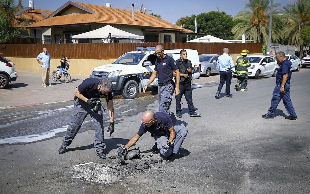 Police and sappers inspecting a rocket fired from Gaza that hit the southern Israeli city of Sderot on October 5, 2016. (Flash90)