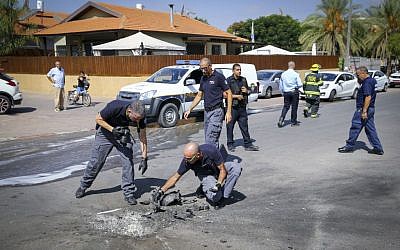 Police and sappers inspecting a rocket fired from Gaza that hit the southern Israeli city of Sderot on October 5, 2016. (Flash90)
