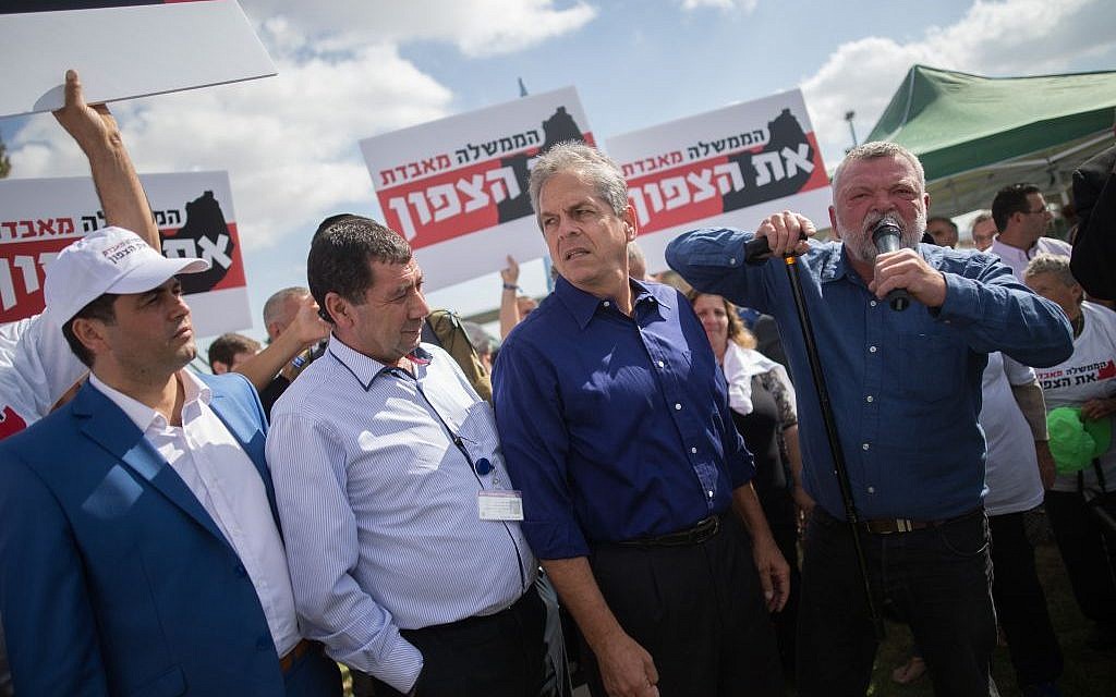 Meretz MK Ilan Gilon (right) speaks during a protest by residents of northern Israel at the Knesset in Jerusalem on October 31, 2016, against proposed budget cuts for their communities.  The banners read: 'The government is losing the north.' (Photo by Yonatan Sindel/Flash90)